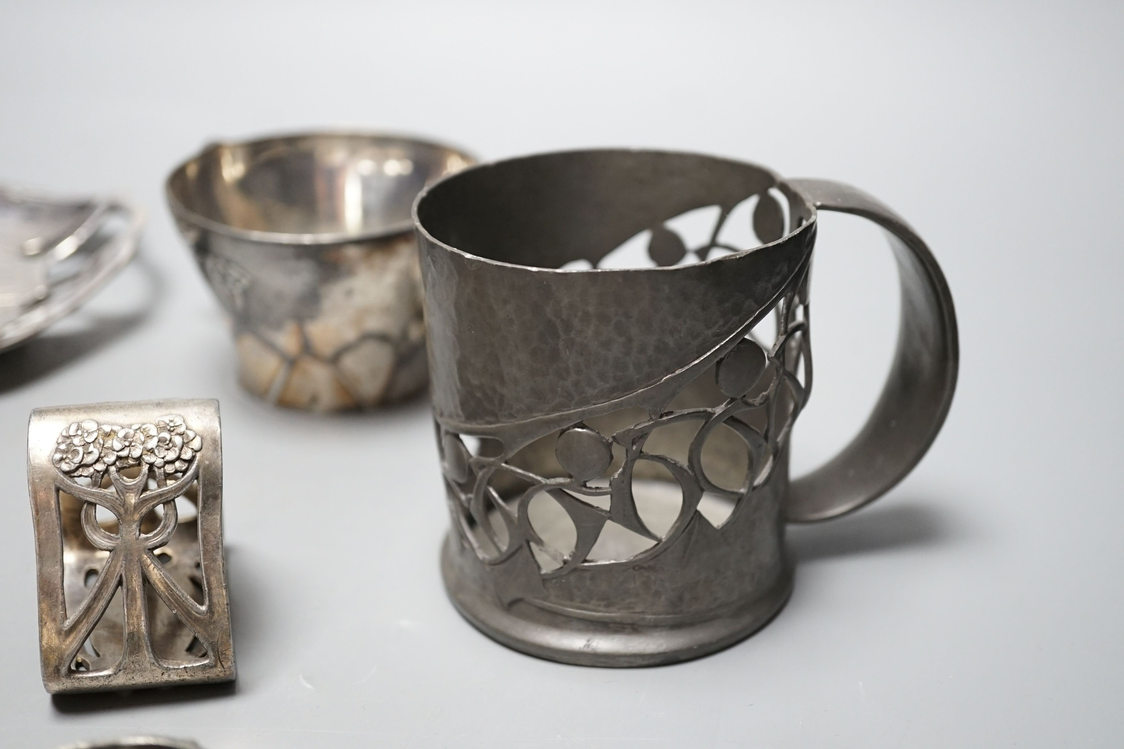 An Arts and Crafts Tudric pewter mug, stamped 534, a pair of WMF napkin rings together with other pewter and metal items, pewter mug 8cms high (9)